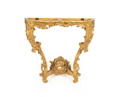 A George II giltwood serpentine console table, the frieze pierced with rocaille, flowerheads and foliage on double C-scroll l