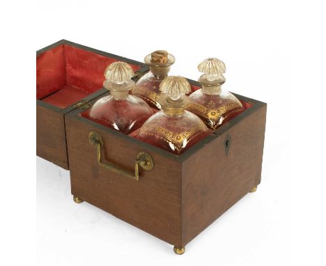 A George III mahogany decanter box containing four square spirit decanters, three with lemon squeezer stoppers, all highlight