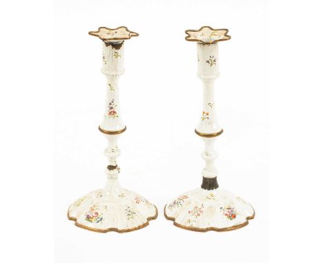 A pair of South Staffordshire white enamel candlesticks, circa 1770, painted with scattered sprays of flowers, 28cm highboth 