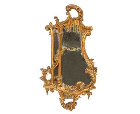 A Victorian mirror of Chippendale design, the divided plate with scrolled and foliate carved frame with rockwork and icicle m