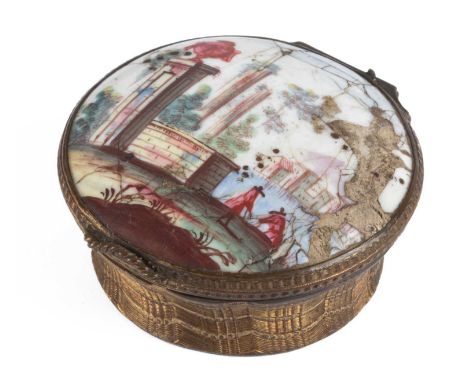 A Continental enamel and gilt metal snuff box, late 18th Century, of circular form, the lid decorated with figures in an arch