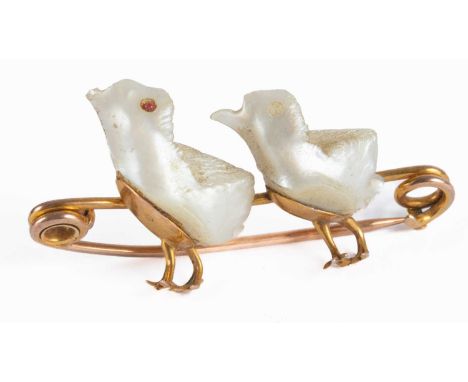 A late Victorian/Edwardian 9ct gold and mother-of-pearl bar brooch, modelled as two chicks, gross weight approximately 6g