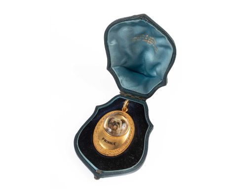 A Victorian Essex crystal pendant locket depicting a terrier, set in an oval mount inscribed 'Prinnie' in enamel and with bea