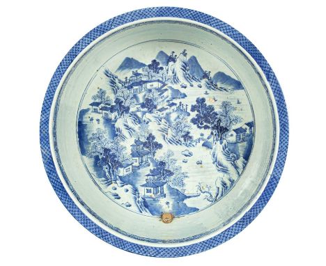 A Chinese blue and white large circular basin, Qianlong, the interior painted with numerous pavilions in a mountainous landsc