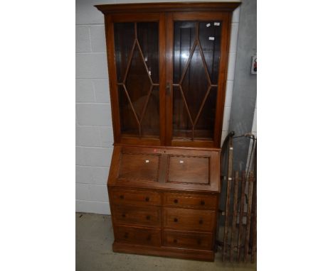 A vintage light mahogany bureau bookcase in the traditional style