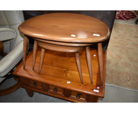 A nest of three Ercol tables, pebble style, mid colour