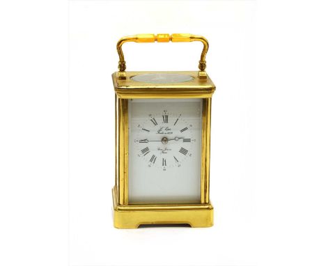 A French brass cased carriage clock, the white enamel dial with Roman numerals, the sides printed with decorative cartouches,