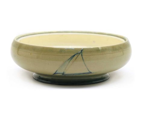 A Moorcroft shallow bowl, first half of the 20th century, tubeline decorated with boats on a pale green ground, lacking cover