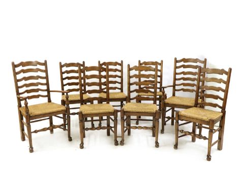 A set of eight ash ladder back chairs, to include a pair of elbow chairs, each with a rush and turned front stretcher, elbow 