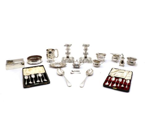 A collection of silver and silver plated items, comprising a small mug, cream jugs, sugar basins, a cruet set, a modern wine 