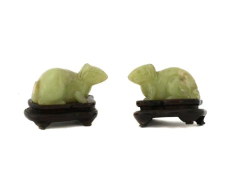 A pair of Chinese jade carvings, late Qing dynasty, each in the form of a recumbent rabbit, 5.5cm long, wood stands (4)Condit