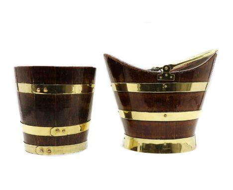 Two brass bound coopered buckets, the first oval, with metal liner and swing handle, the second circular. 27cm diameter, and 