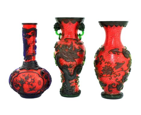 Three Chinese overlay Peking glass vases, 20th century, comprising: one of baluster form, decorated with two dragons chasing 