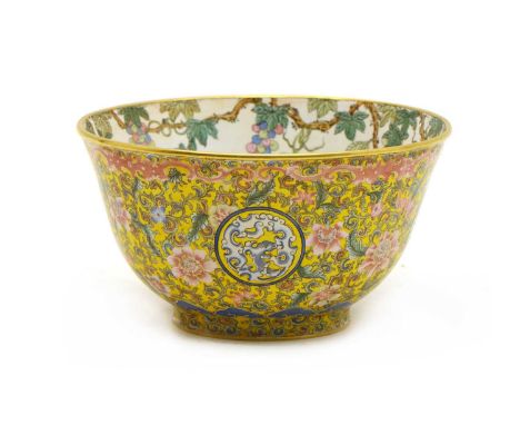 A Chinese painted enamel bowl, the rounded sides rising from a circular foot to a flared rim, painted with chilong roundels s