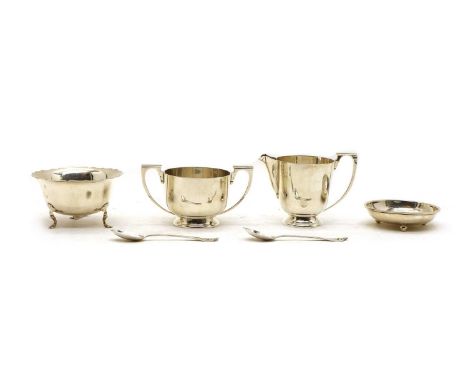 A collection of silver items, comprising cream jug and sucrier, bowl on tripod paw feet, a shallow dish and two teaspoons, 13