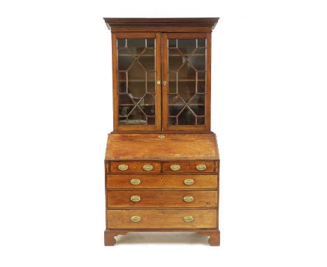 A George III mahogany bureau bookcase, the astragal glazed bookcase over a fitted bureau, 2 short and 3 long drawers and brac