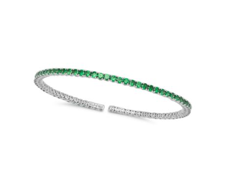 A TSAVORITE GARNET BANGLE in 18ct white gold, the open bracelet set with a row of round cut tsavorite garnets, stamped 750, i