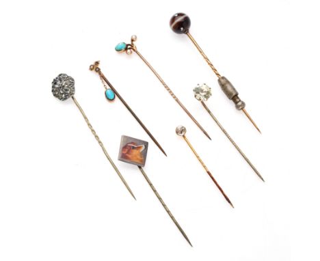 NO RESERVE - A GROUP OF STICK / TIE PINS comprising a banded agate pin, a white paste stone pin, an enamel dog pin, a paste c