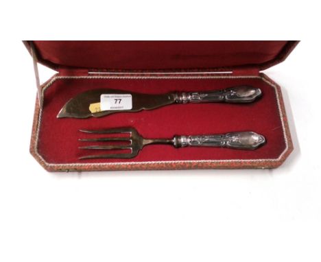 A white metal handled fish serving knife and fork in fitted case