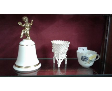 A Meissen floral decorated cup; together with a small Belleek vase; and a Royal Doulton bell mounted with a cherub 