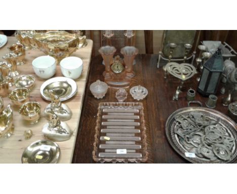 A pink glass dressing table set comprising of candlesticks, two vases, clock etc.