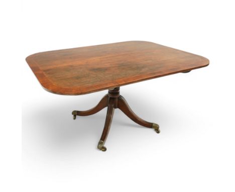 Early 19th century Sheraton style mahogany and rosewood pedestal breakfast table, the rectangular top with rounded corners an