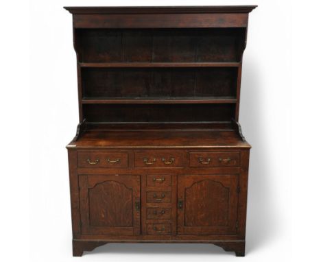 Early 19th century oak dresser, raised two heights plate rack with projecting moulded cornice and shaped end supports, rectan