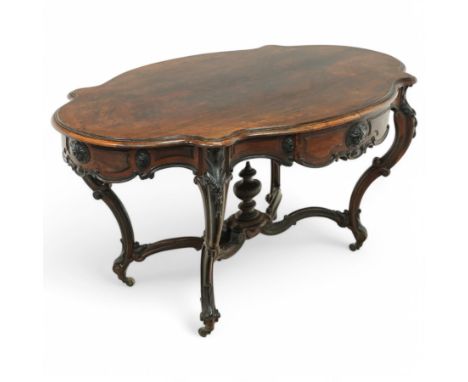 Victorian rosewood centre table, the top of serpentine form with scroll carved moulded edge and shaped apron with carved pate