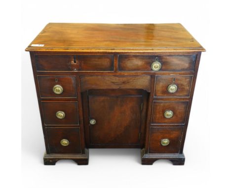 George III mahogany kneehole desk, moulded rectangular top over eight cock-beaded drawers with circular pressed brass handle 