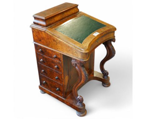 Victorian figured walnut Davenport desk, raised ogee hinged compartment enclosing divisions, sloped hinged lid, the interior 