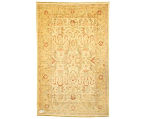 Ziegler design hand-knotted wool rug, the central field with symmetrical scrolling floral motifs in muted tones of beige, sag