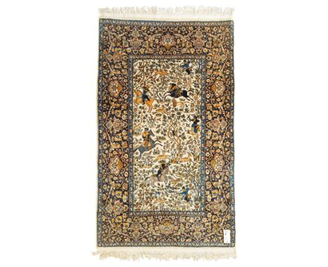Persian pictorial rug featuring a hunting scene, ivory field with mounted hunters, animals, birds and trees, rich navy and te
