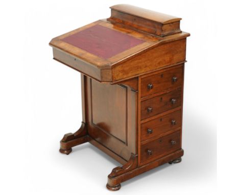 Late Victorian walnut Davenport with writing slope and stationery compartment. four side drawers with dummy drawers to the re