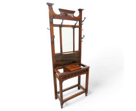 Late 19th century walnut hallstand, pierced pediment over rectangular bevelled mirror, tiled back and hinged glove compartmen