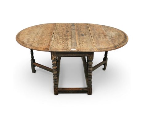 Late 17th century oak drop-leaf dining table, oval drop-leaf top on gate-leg action base, bobbin turned supports untied by mo