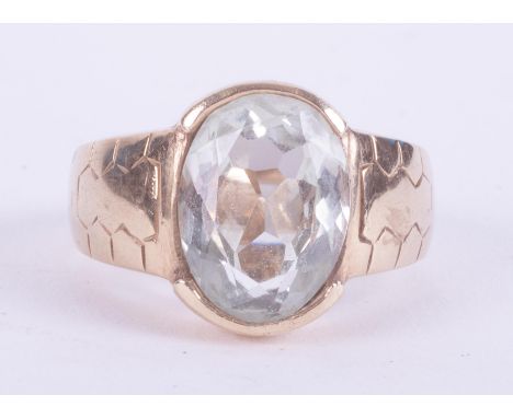 A 9ct yellow gold ring set with an oval mixed cut aquamarine, approx. 4.84 carats, with engraved shoulders, 6.00gm, size P.