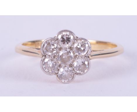 An 18ct yellow gold &amp; platinum daisy ring set with old round cut diamonds, 2.20gm, size L 1/2 to M.