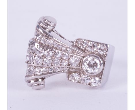 An impressive platinum 1950's ring in the style of the Art Deco period in a geometric scroll design set with round cut diamon