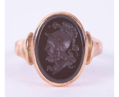 A 15ct yellow gold signet ring set with a black onyx seal with a picture of a Roman Centurion?, 6.50gm, size R 1/2 to S.