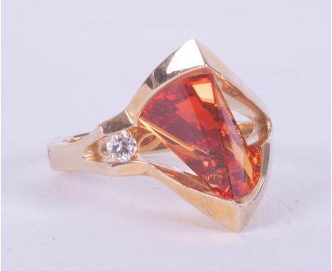 An unusual vintage designer 14k yellow gold ring by Strell (Strellman) set with a fantasy cut orange sapphire (lab created?) 