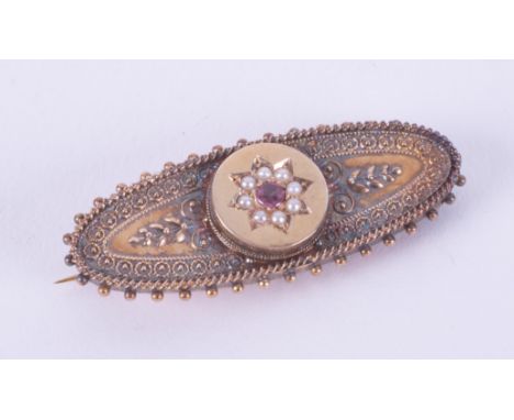 A 15ct yellow gold ornate Victorian brooch set with a round cut ruby &amp; seed pearls, length 4.5cm, 5.20gm, boxed.