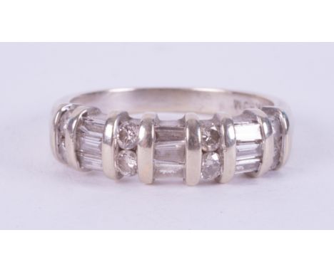 A 14k white gold ring set with a mixture of round brilliant cut &amp; baguette cut diamonds, 3.77gm, size N.