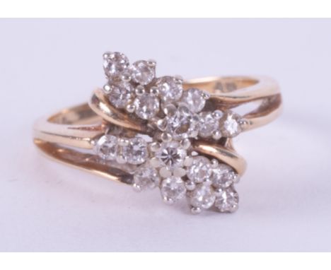 An 18ct yellow gold crossover style ring set with small round brilliant cut diamonds, 3.55gm, size L.