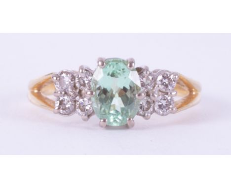 An 18ct yellow &amp; white gold bespoke hand made ring set with a central oval cut Paraiba tourmaline, approx. 1.14 carats se