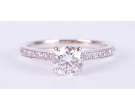 An 18ct white gold ring set with a central round brilliant cut diamond, approx. 0.65 carats, colour H-I and SI2 clarity, with