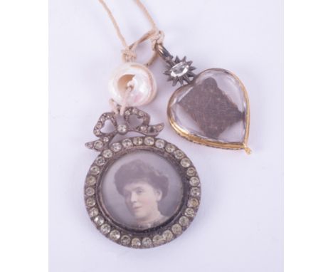 A gold &amp; black enamel George II heart shaped mourning locket with an old oval cut diamond to the top set in a twelve poin