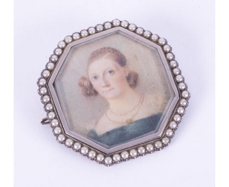 An antique silver (hallmarks are indistinct on reverse) portrait brooch of a lady in a blue dress, surrounded by seed pearls,