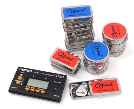Approximately five hundred Ozark plectrums within branded tin cases; together with a Boss TU-80 tuner and metronome 