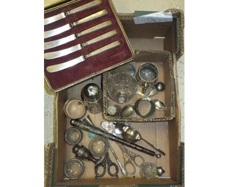 A box of assorted silver and plated items to include tea strainer, grenade scent bottle, Christening mug, etc