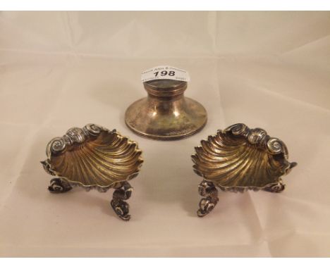 A pair of Victorian silver shell shaped salts (London, 1895), together with a George V silver capstan inkwell of small propor